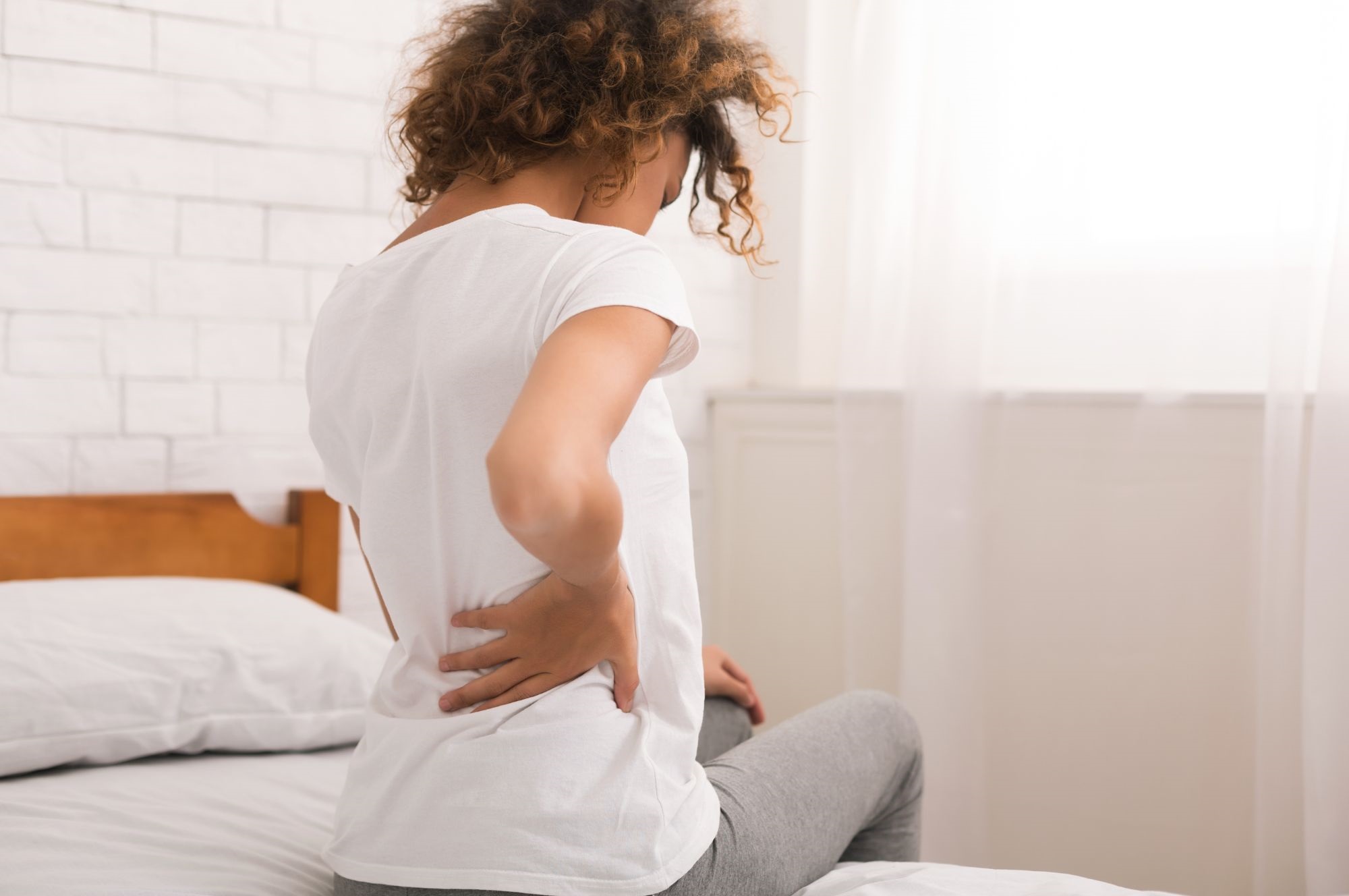 A Woman With A Lower Back Pain After Sleeping